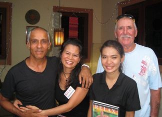 Mukesh Thakker and Bob Neylon pose with the staff at The Relax Bar.