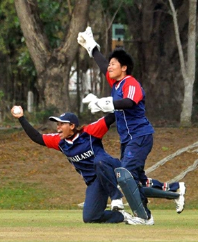 Thai players celebrate taking a wicket against China in the final.