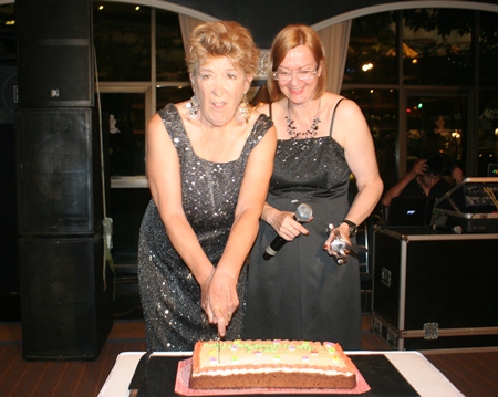 Outgoing and incoming presidents Ann Winfield and Helle Rantsen share a cake cutting.