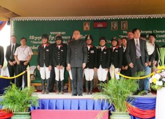 Lily-Mae Toon stands on stage amongst other riders.