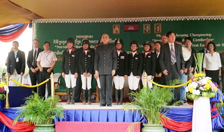 Lily-Mae Toon stands on stage amongst other riders.
