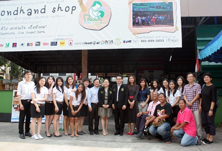 Students, honored guests and officials celebrate the opening of the new secondhand shop.