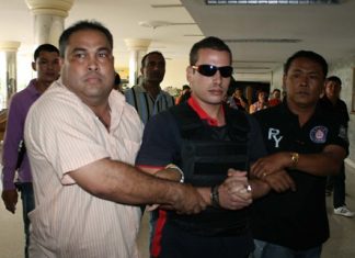 Police bring Mohamad Shanar Ryad into the Jomtien Complex to reenact the murder.