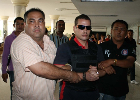 Police bring Mohamad Shanar Ryad into the Jomtien Complex to reenact the murder.