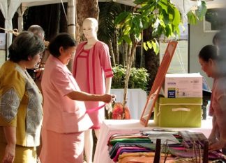 HRH Princess Maha Chakri Sirindhorn inspects some of the Mudmee silk on display at the celebration of the 150th anniversary of Queen Savang Vadhana’s birth.