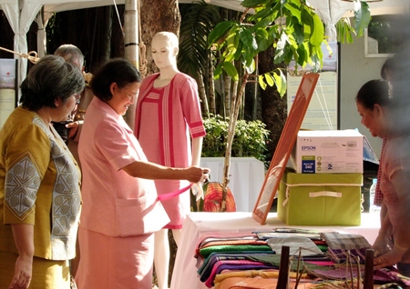 HRH Princess Maha Chakri Sirindhorn inspects some of the Mudmee silk on display at the celebration of the 150th anniversary of Queen Savang Vadhana’s birth.