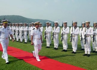 Myanmar’s top naval commander, Rear Adm. Tulataed Chuay walks the red carpet to inspect a Thai Marine Corps honor guard of 100 sailors.