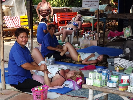 Chanhom Ngamdee quit her permanent job to join other women on Wong Amat Beach, laying mats to offer mobile massage and beauty services.