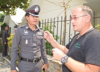With a backdrop of bullet holes in his neighbor’s house, Bryan Anderson (right) tells police what he heard.