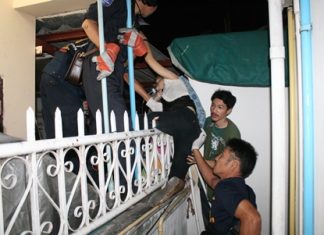 Rescue workers try to free the impaled woman from the iron fence, but in the end needed to cut the fence and transport her to the hospital with the pointed prong still in her leg.