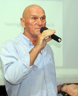 PCEC Member Chris Harman introduces long time friend Doug Campbell, a former speech and debate coach.