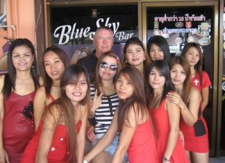 Kit (center rear) poses with the staff at Blue Sky Bar.