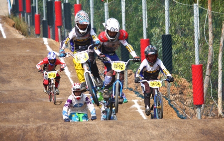 Cyclists leap over the undulations during one of the male category races.