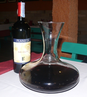 Planeto Merlot 2003, which was an excellent wine and at 15 percent, potent as well, was decanted in front of us.