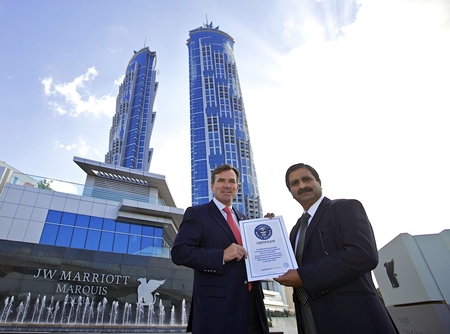 Rupprecht Queitsch, General Manager of the JW Marriott Marquis Hotel Dubai is joined by Ashok Korgaonkar, leading architect of the building and Managing Director of Archgroup Consultants, as they receive the official Guinness World Record certificate for the world’s tallest hotel.