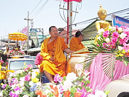 Revered monks sprinkle holy water on the masses.
