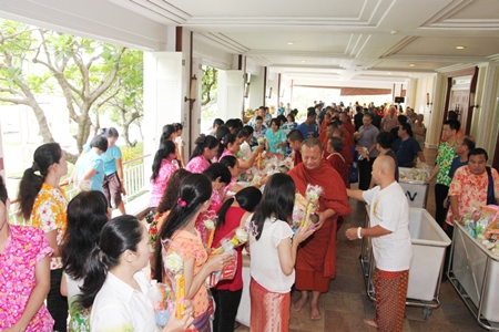 The foyer outside the Dusit Thani Pattaya’s Napalai Convention Hall is filled with hotel guests and staff who make merit by giving donations to the twenty-nine monks, who will later distribute the goods to among the community.