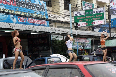 Car stereos set to full blast prompt the girls in Sattahip to shake their booties.