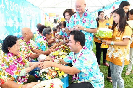 The mayor and council members pour water on elders in the Naklua community.