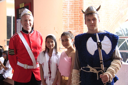 Principal Mike Walton (left) in traditional dress with students.