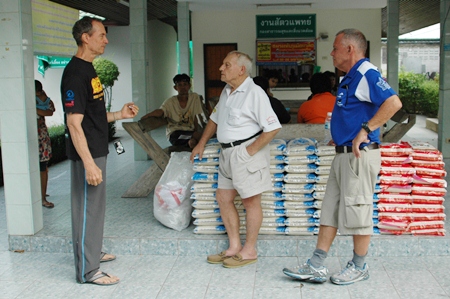 (L too R) Woody Underwood, Bernie Tuppin and Bill Freeman prepare to help deliver donated rice.