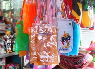 Plastic pouches for keeping valuables dry during Songkran hang for sale among the water guns and other paraphernalia.