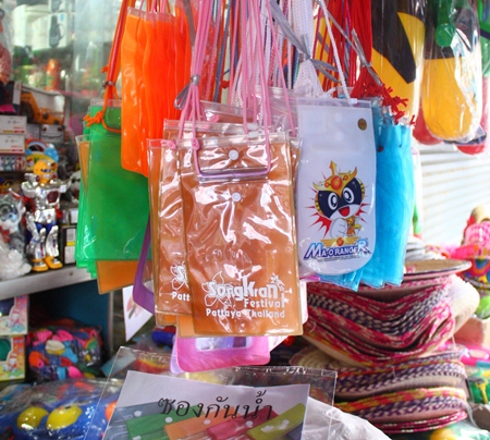 Plastic pouches for keeping valuables dry during Songkran hang for sale among the water guns and other paraphernalia.