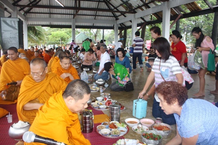 Sattahip residents present alms to local monks as part of the region’s official Songkran commemoration.