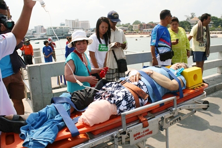 Rescue workers bring in Gih Wa Hong, 63, who lost part of his leg in the accident.
