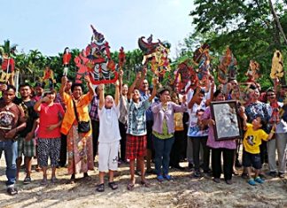 Cast and crew hold up shadow puppets during announcement for the upcoming Nang Talung Shadow Play Preservation Center.