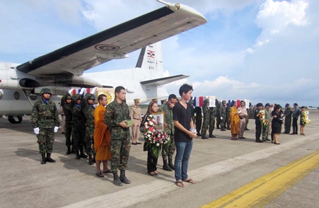 Family and comrades gather on the tarmac at Sattahip Naval Base to bring home the bodies of three marines killed by a booby-trapped bomb in Thailand’s restive south.