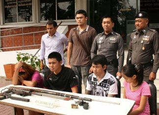 Police bring out the suspects for a perp walk in front of the media.