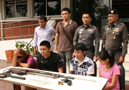 Police bring out the suspects for a perp walk in front of the media.