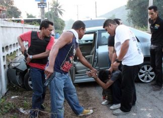 Guns drawn, police extract drug suspect Kriangwuth Sricharoen from his vehicle after a lengthy car chase.