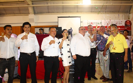 Hafele administrators, led by MD Volker Hellstern (5th left), popping open the champagne to celebrate the 90th Anniversary of Hafele Germany at Hafele Design Studio Pattaya, South Pattaya.