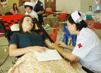 Nurse Kotchakorn Auamsamang (right), chief of the blood donation unit at Sriracha’s Ratchathewi Hospital, Sriracha, attends to a donor.