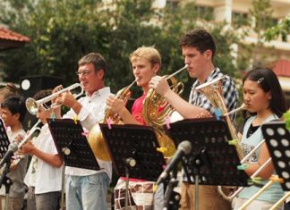 Students and staff perform alongside each other.