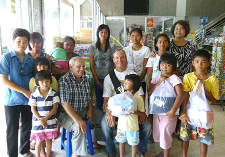 Woody and Bernie (seated center) say that outfitting these children for school is something the Jesters Care for Kids are happy to do.