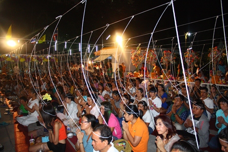 Folks attend the casting of Lord Buddha’s statue, the head being cast in gold, at Wat Chaiyamongkol.