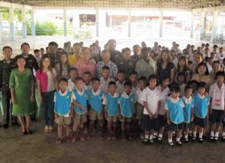 Students, teachers, officials and benefactors gather round for a group photo during the presentation ceremony.