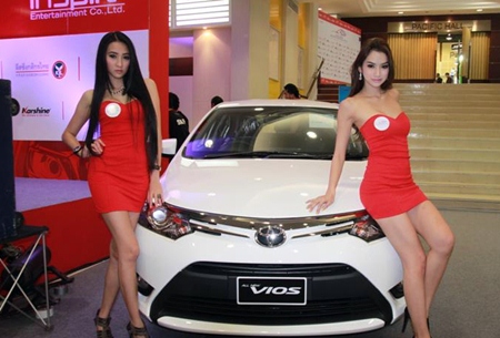 Brolly dollies drape themselves over a Toyota Vios at the Thailand Motor Festival in Sriracha.