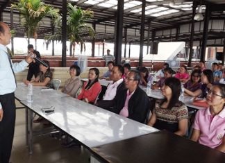 Thongsuk Mantathorn (left) teaches local officials to be polite when performing their duties.