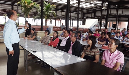 Thongsuk Mantathorn (left) teaches local officials to be polite when performing their duties.
