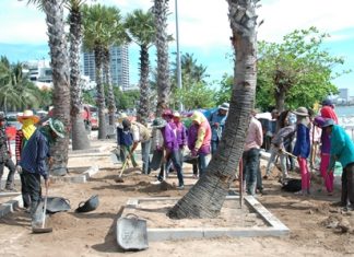 Laborers, some shown here improving the diminishing beach landscape for the May Day celebration, say 300 baht a day is still not enough for them to make ends meet in today’s ever changing economy.