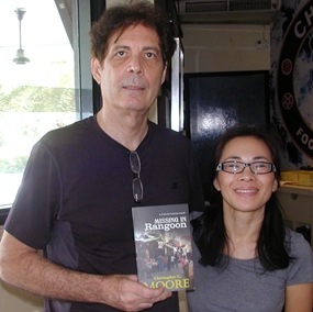 Christopher and wife Od show one of his latest books, ‘Missing in Rangoon’.