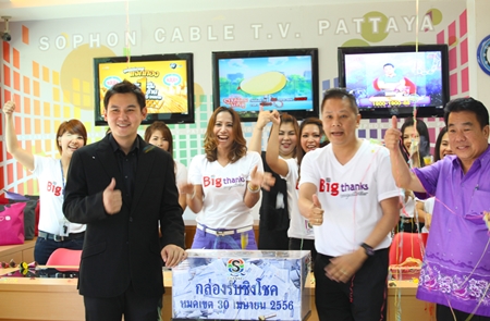 Rattakit Hengtrakul (left), assistant MD of services at Sophon Cable TV Pattaya, along with GM Attasitthi Chuachuchart and staff seal the coupon box in preparation of the big drawing on May 18.