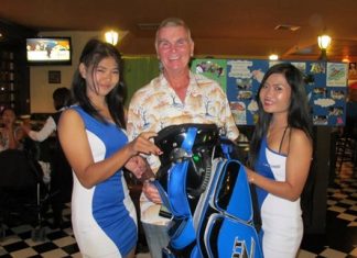 A Flight winner Jeff Wylie (center) collects his prize.