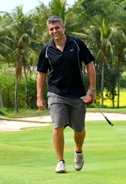 Andrew Harrison, Head of St. Andrews International School, strides to the green.