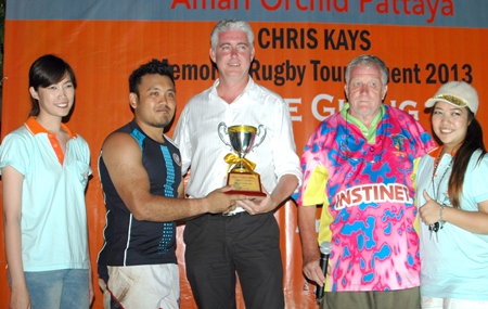 Brendan Daly, General Manager of the Amari Orchid Resort Pattaya (center) presents the Cup to the captain of the Thai Barbarians (2nd left) at the conclusion of the 2013 Amari Orchid Pattaya Chris Kays Memorial Rugby Tournament at Horseshoe Point, Sunday, May 5.