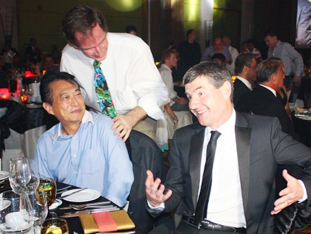 Dennis Irwin (right) jokes with guests at the dinner table.